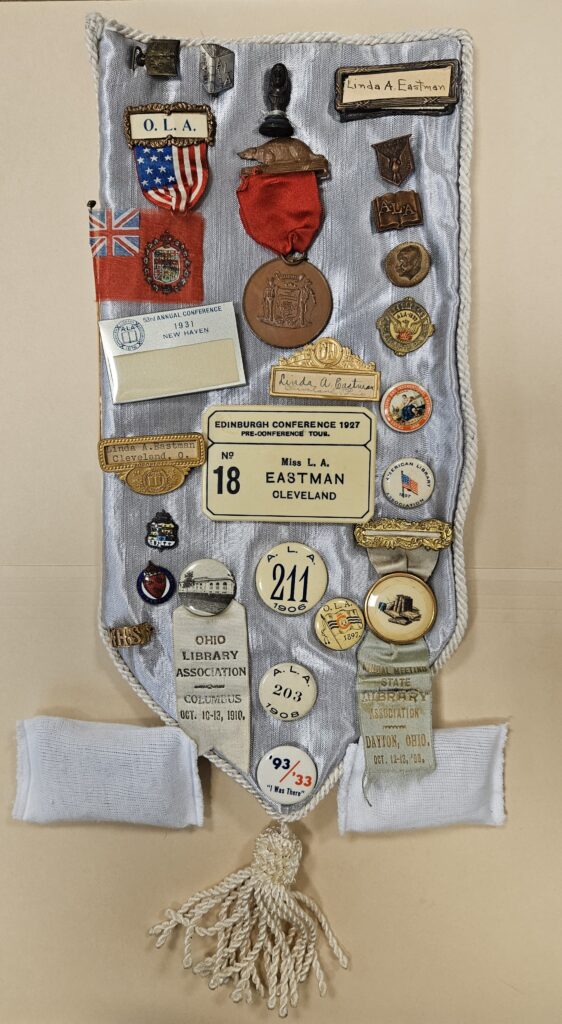 A sash displaying Linda Eastman's collection of buttons and pins from professional conferences